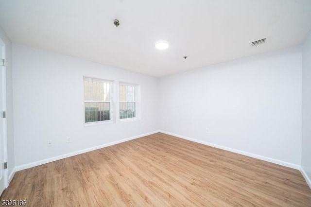 unfurnished room with light wood-type flooring