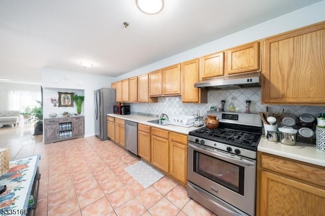 kitchen with backsplash, stainless steel appliances, sink, and light tile patterned flooring