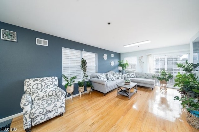 living room with a wealth of natural light and light wood-type flooring