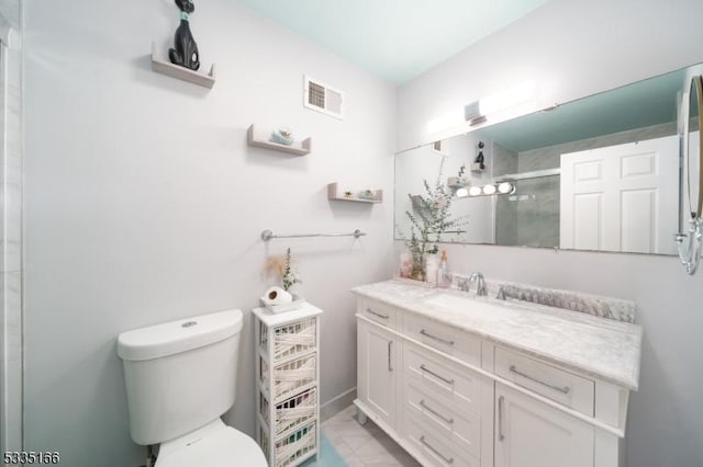 bathroom featuring vanity, toilet, and walk in shower