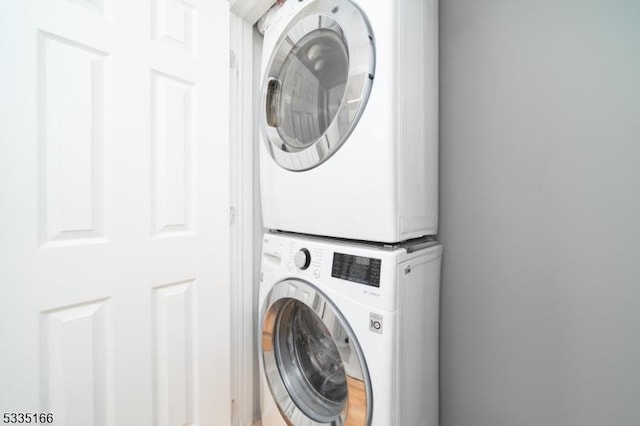 washroom featuring stacked washer and dryer