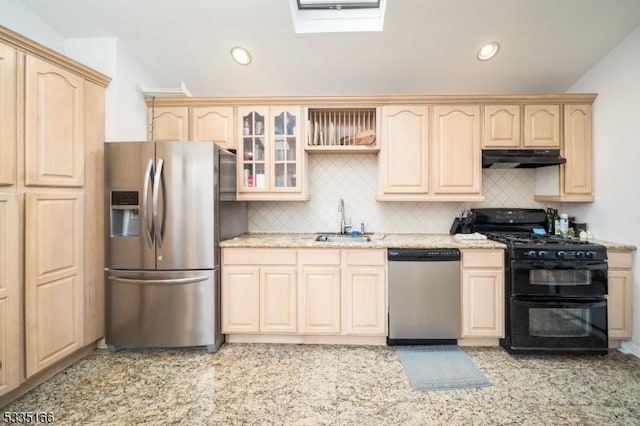 kitchen with appliances with stainless steel finishes, sink, decorative backsplash, and light brown cabinets