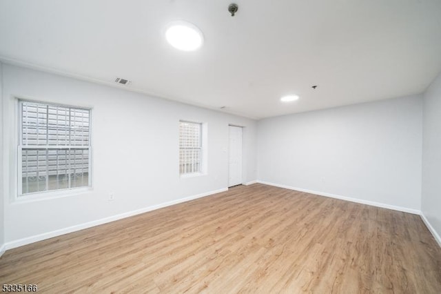 empty room with light hardwood / wood-style floors