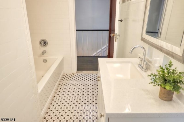 bathroom featuring vanity, tile patterned floors, and tiled shower / bath