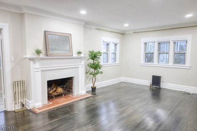 unfurnished living room featuring ornamental molding, dark wood-type flooring, and radiator