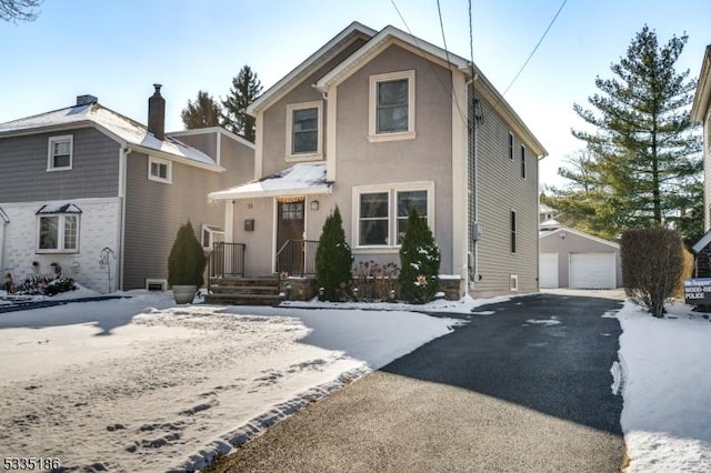 view of front property with a garage and an outdoor structure