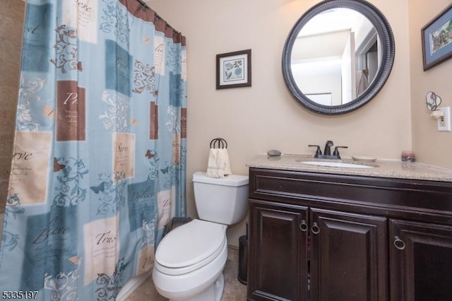 bathroom with vanity, curtained shower, and toilet