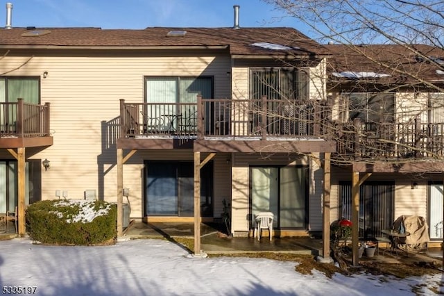 snow covered house with a balcony