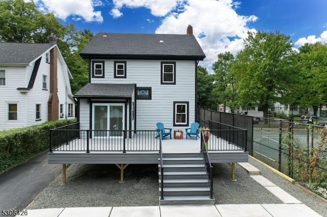 back of property with a wooden deck