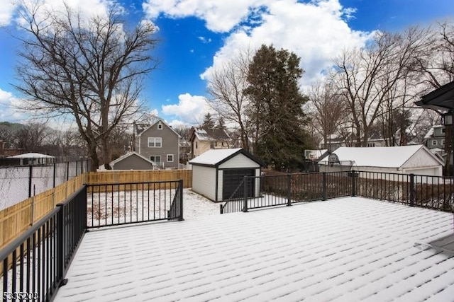 snow covered deck with a storage shed