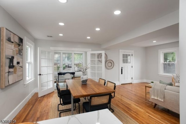 dining room with french doors and light wood-type flooring