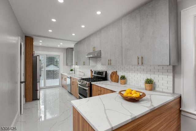 kitchen featuring stainless steel appliances, kitchen peninsula, light stone countertops, and backsplash