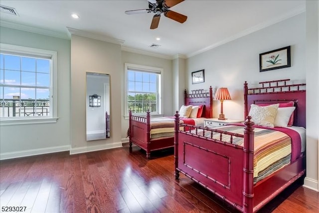 bedroom with crown molding, dark wood-type flooring, and ceiling fan