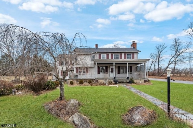 view of front facade with covered porch and a front lawn