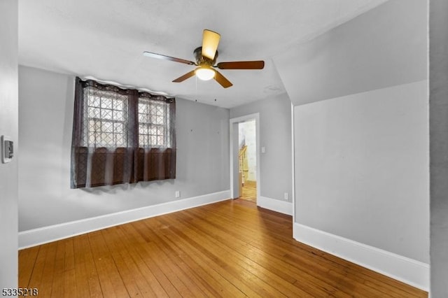 empty room with hardwood / wood-style floors and ceiling fan