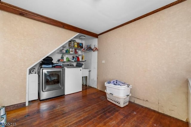 clothes washing area with dark hardwood / wood-style flooring, crown molding, and independent washer and dryer