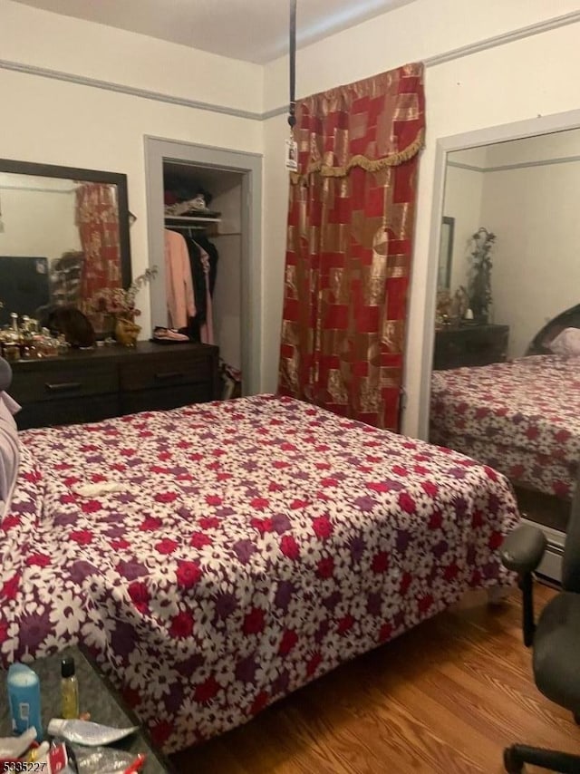 bedroom featuring hardwood / wood-style flooring and a closet