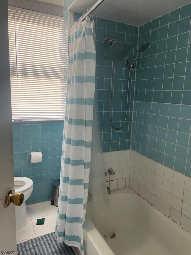 bathroom featuring tile walls, shower / tub combo with curtain, tile patterned floors, and toilet