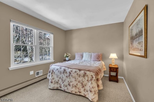 bedroom featuring a baseboard heating unit and carpet floors