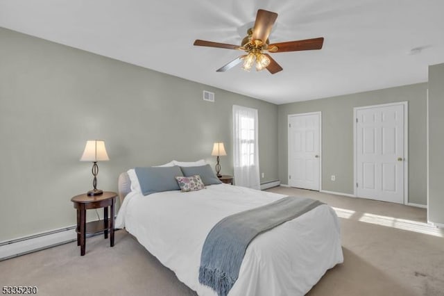 bedroom featuring a baseboard heating unit, light carpet, and ceiling fan