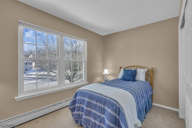 carpeted bedroom with a baseboard heating unit and a closet