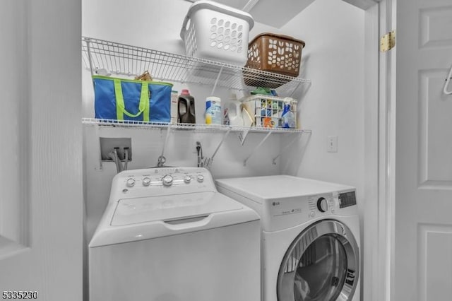 clothes washing area featuring washing machine and clothes dryer