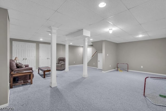 basement featuring carpet and a paneled ceiling