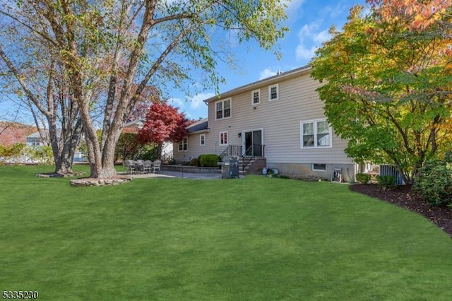 rear view of house with a lawn