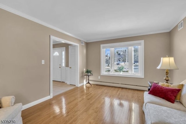 living area with a baseboard heating unit, light hardwood / wood-style flooring, and ornamental molding