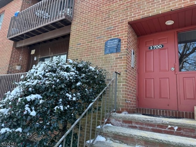 view of snow covered property entrance