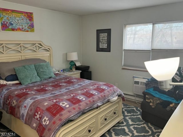 bedroom featuring baseboard heating and a wall mounted air conditioner