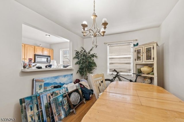 dining space with a notable chandelier and hardwood / wood-style floors