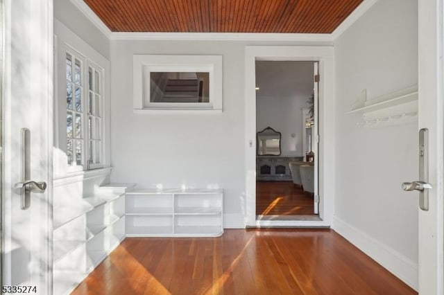 hall featuring hardwood / wood-style floors, crown molding, and wooden ceiling