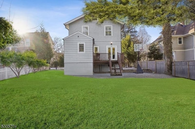 rear view of property with a wooden deck and a yard