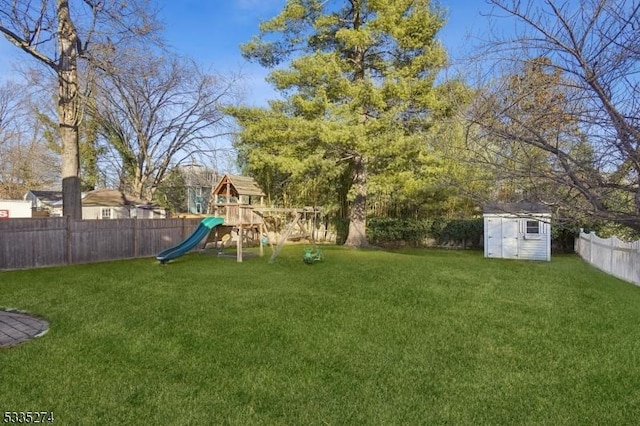 view of yard with a playground and a storage unit