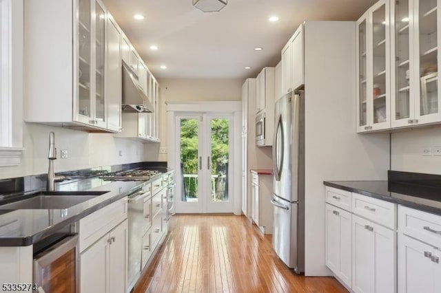 kitchen with stainless steel appliances, sink, and white cabinets