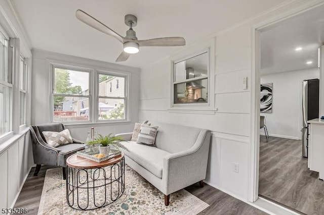 sitting room with dark hardwood / wood-style floors and ceiling fan