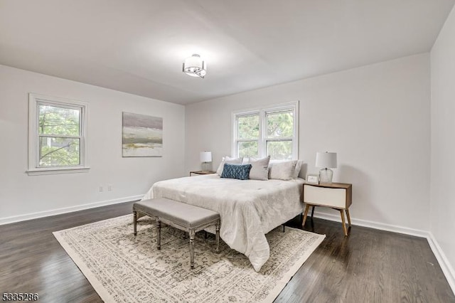 bedroom featuring dark hardwood / wood-style flooring and multiple windows