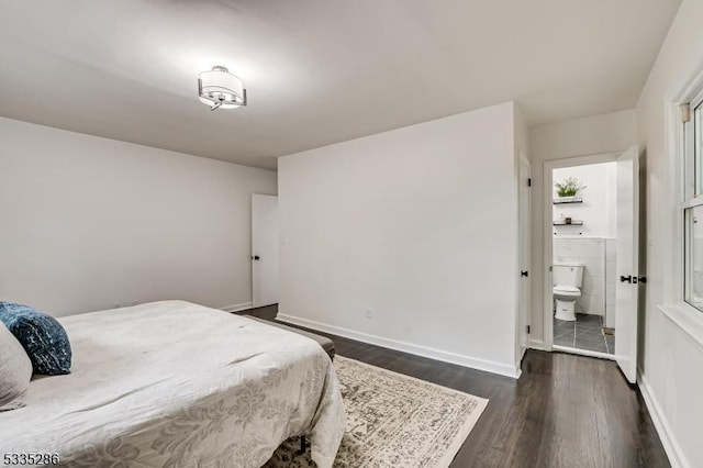 bedroom with dark wood-type flooring and ensuite bathroom