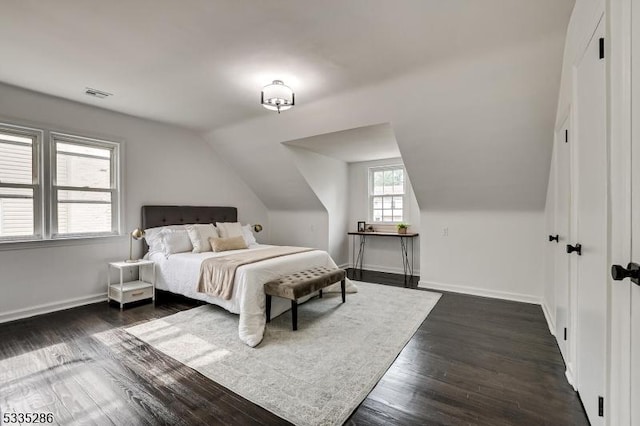 bedroom featuring dark wood-type flooring and vaulted ceiling