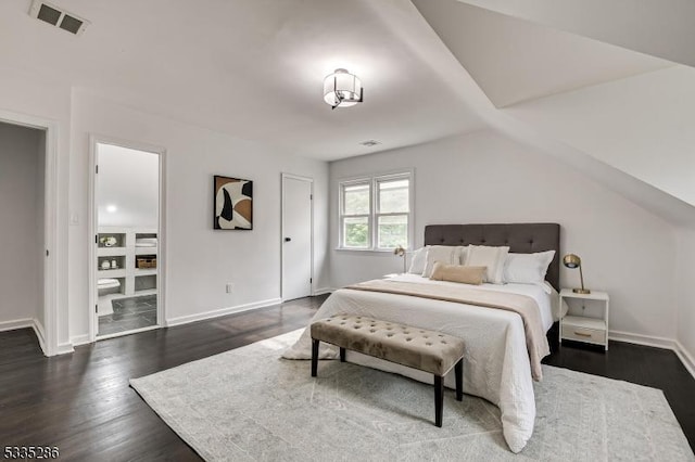 bedroom with lofted ceiling and dark hardwood / wood-style flooring