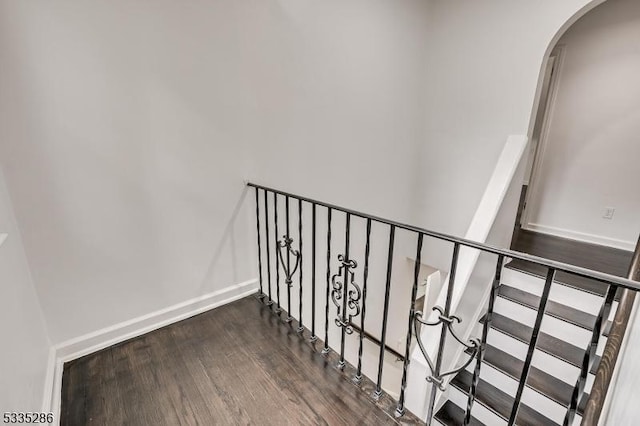 staircase with hardwood / wood-style flooring