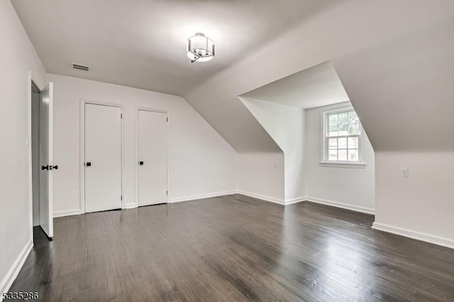 bonus room featuring dark hardwood / wood-style flooring and lofted ceiling