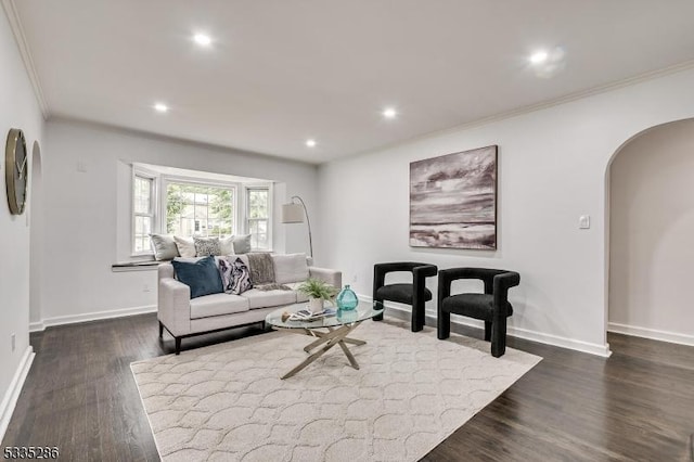 living room with crown molding and dark hardwood / wood-style floors