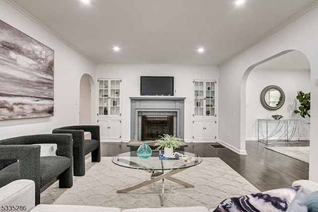 living room featuring hardwood / wood-style floors and crown molding