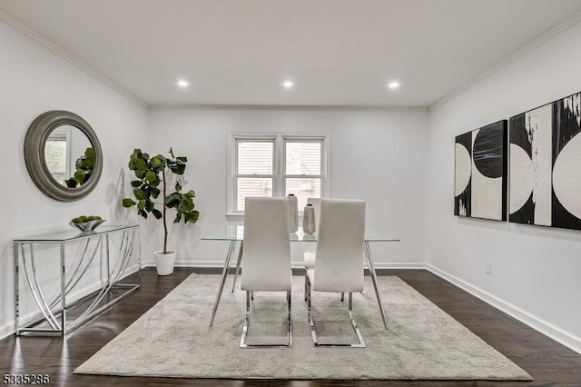 dining area featuring ornamental molding and dark wood-type flooring