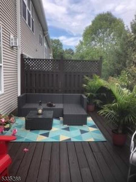 wooden deck with an outdoor living space with a fire pit