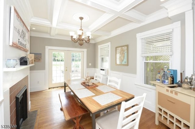 dining room with beam ceiling, dark hardwood / wood-style floors, and french doors