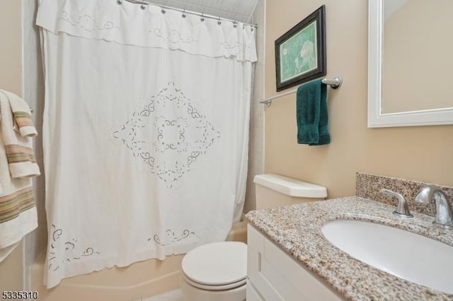 full bathroom featuring toilet, vanity, and shower / bathtub combination with curtain