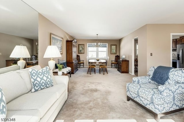 carpeted living room with a notable chandelier